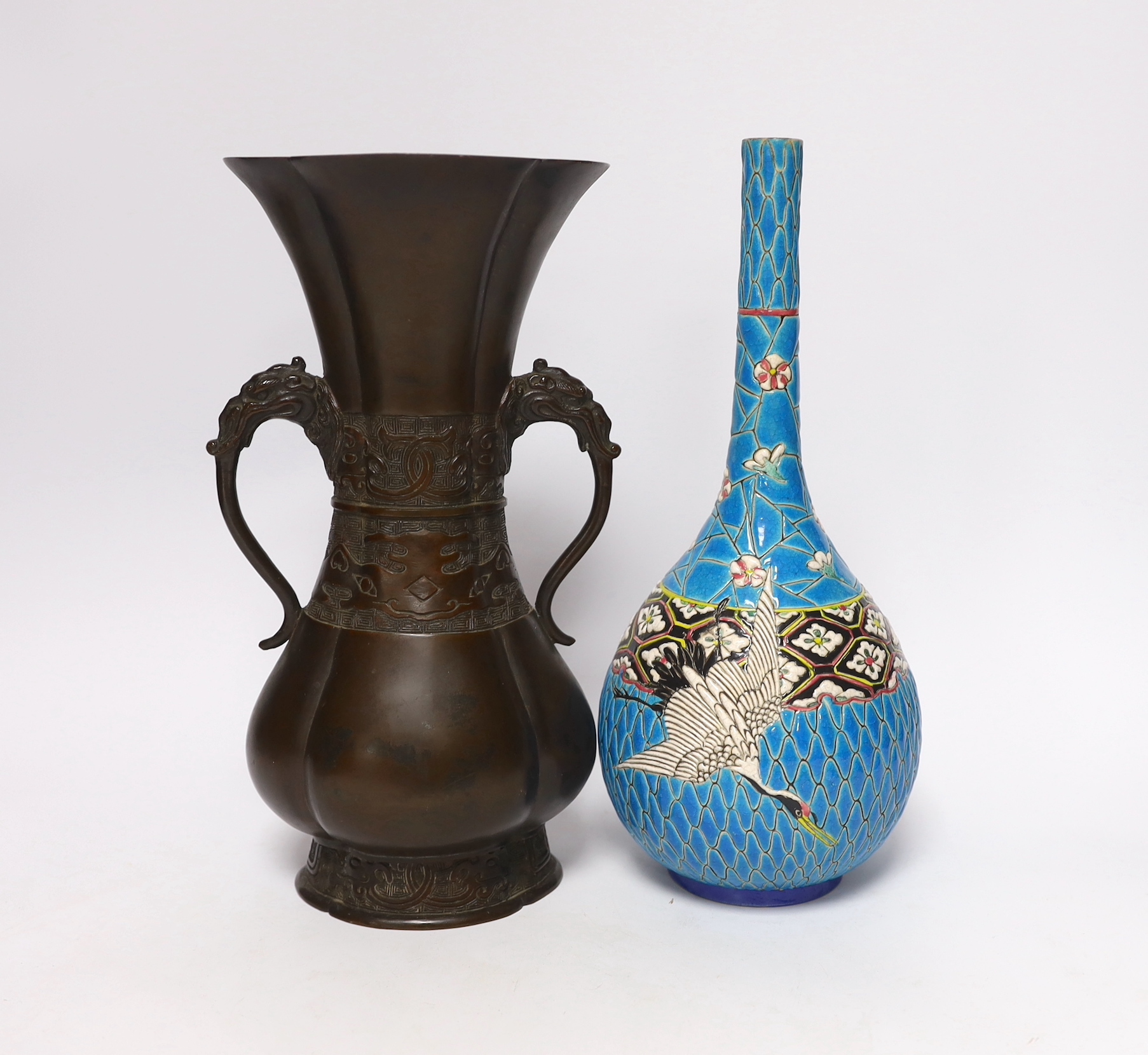 A 19th century Japanese bronze flower vase, with a Japanese enamelled pottery bottle, Meiji, tallest 27 cm (2)